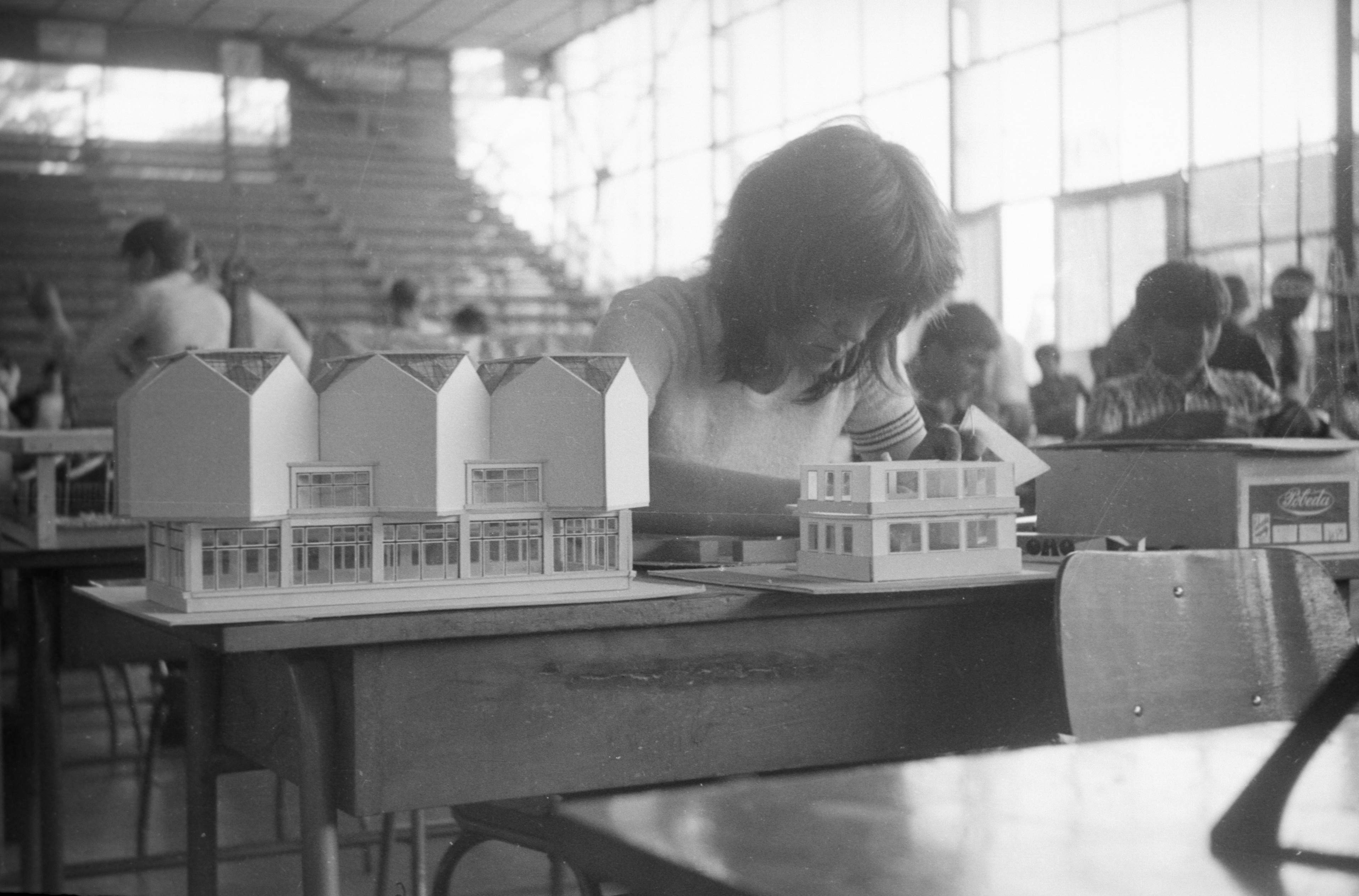 Don't know who this is, but her model of the Museum of modern art is perfect. The chairs and desks are probably from the nearest school.